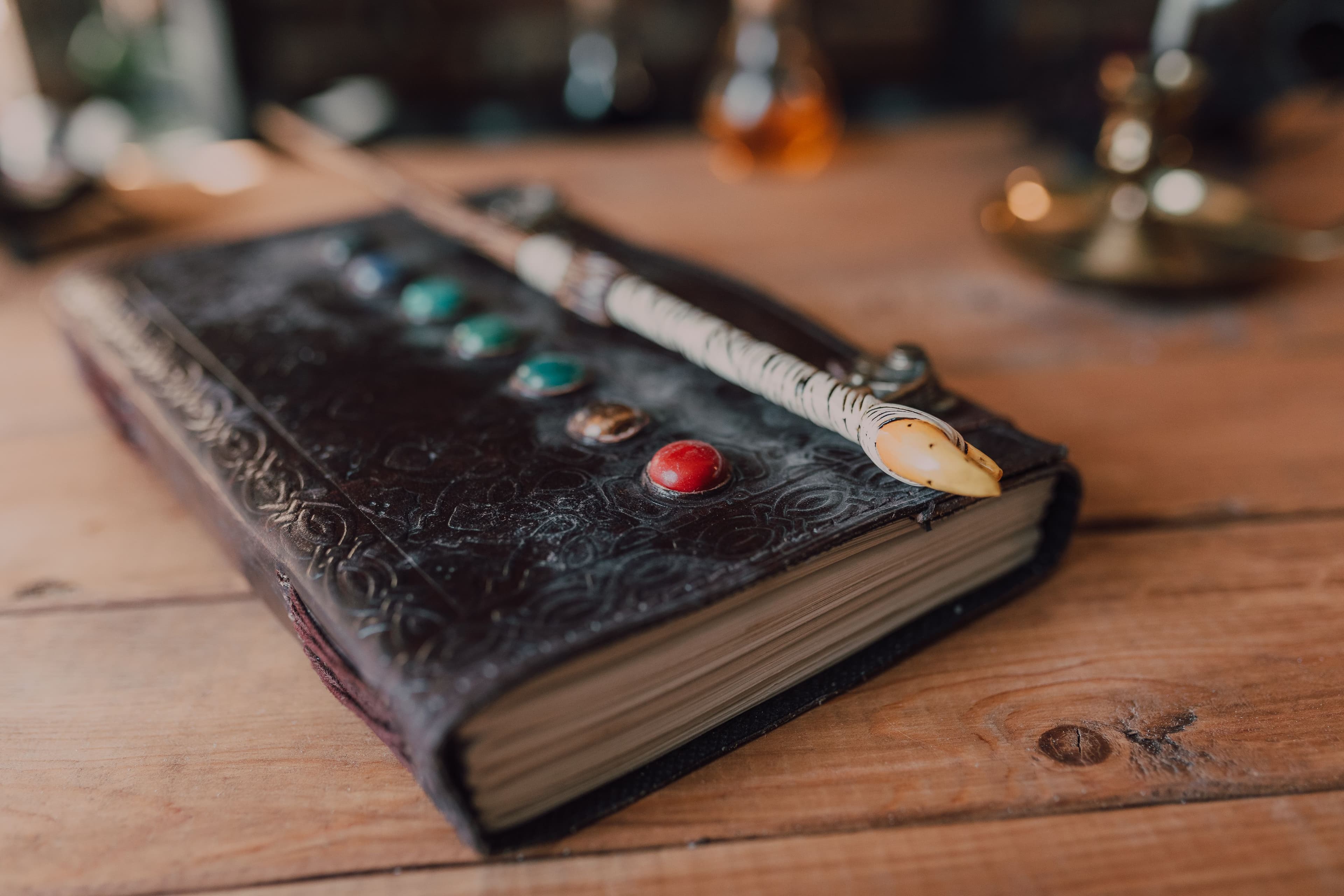 An embossed leather-bound journal resting on a wooden desk